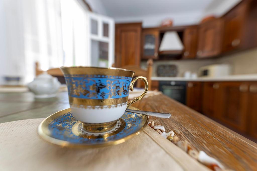 a blue and gold coffee cup sitting on a table at Villa Areto in Kamares
