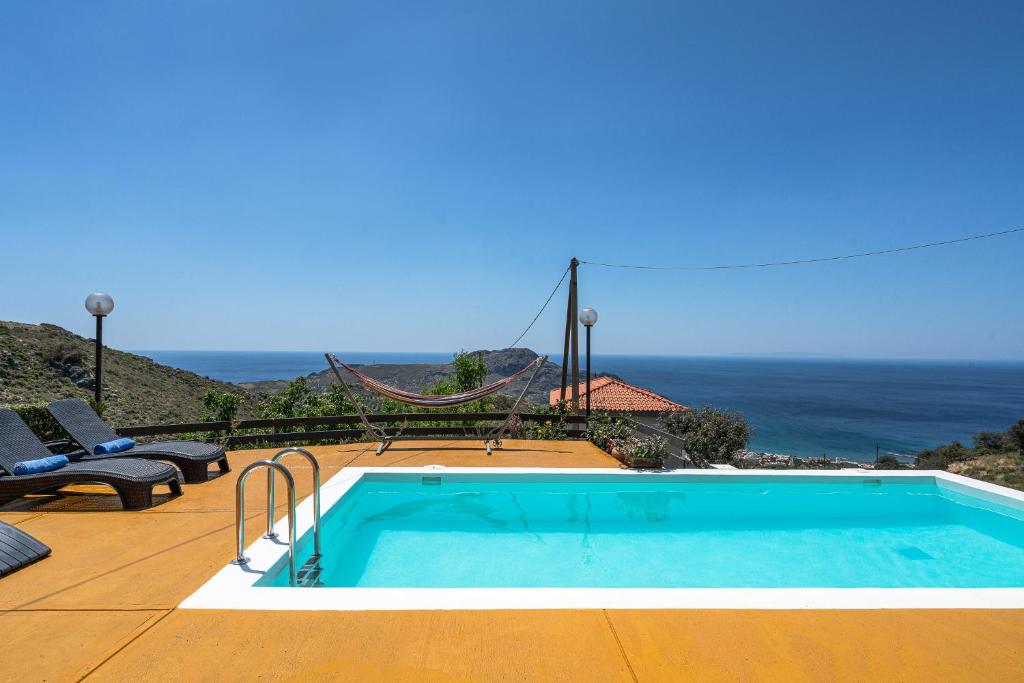 a swimming pool with a view of the ocean at Seaview Villa Mirthios Panorama with Private Swimming Pool and BBQ! in Plakias