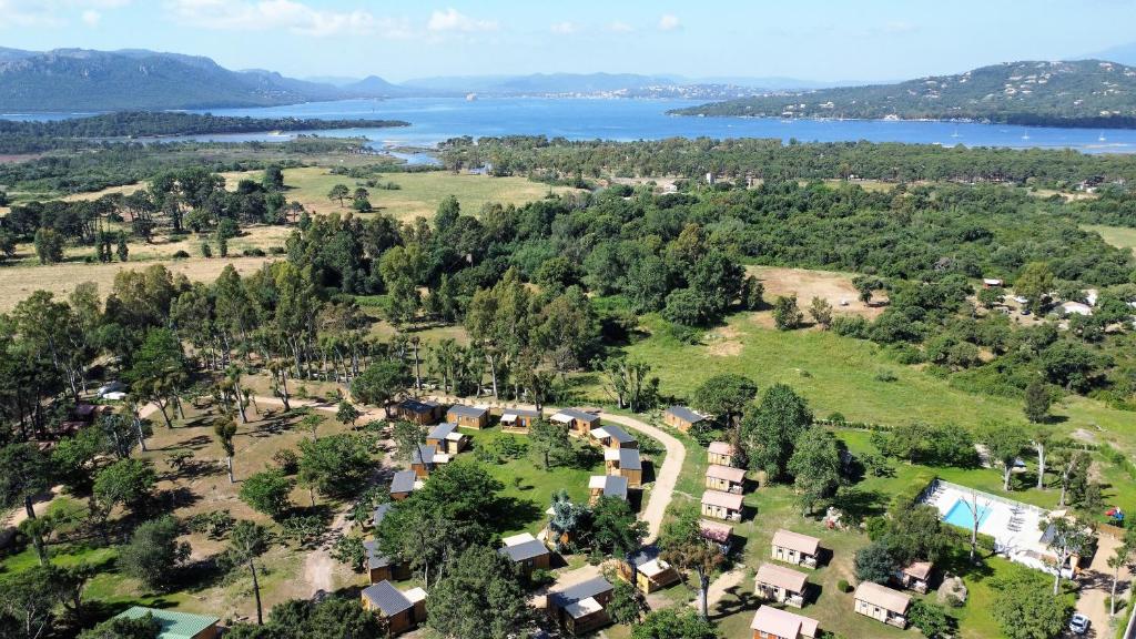 an aerial view of a village with a lake at Camping l'Oso in Porto-Vecchio