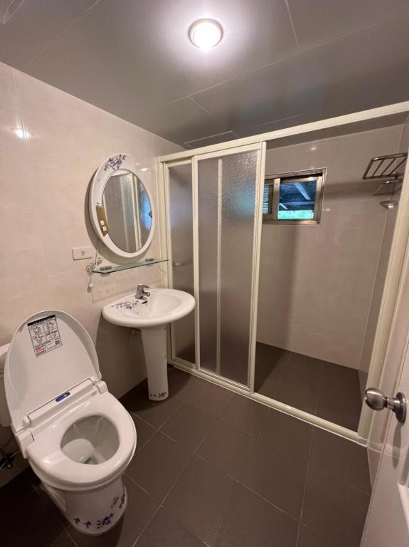 a bathroom with a shower and a toilet and a sink at Cingjing Four Seasons B&amp;B in Ren&#39;ai