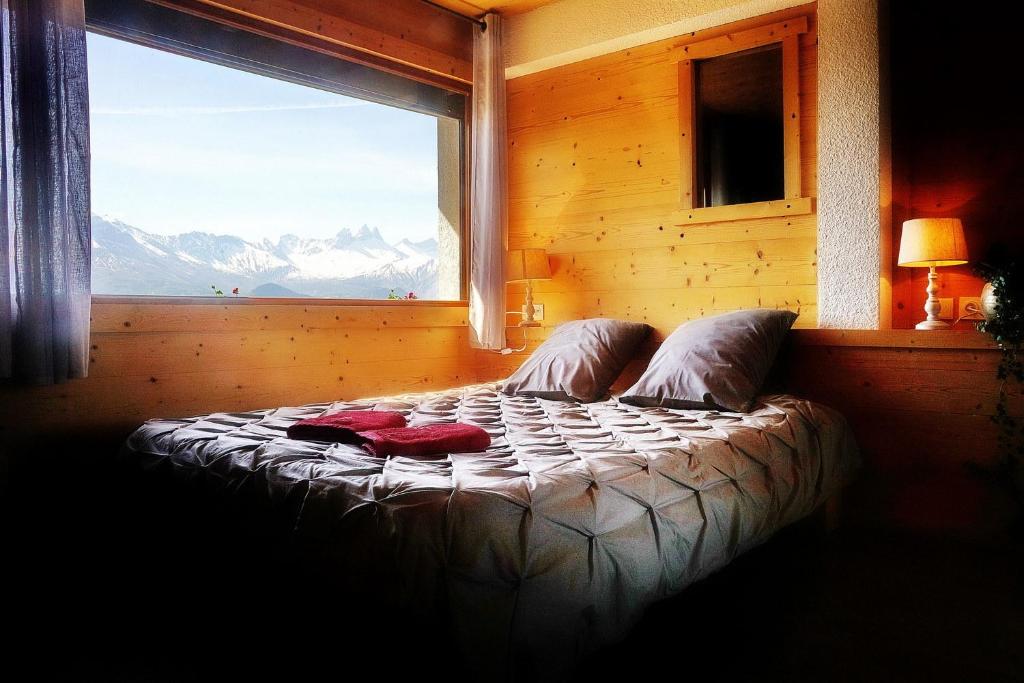 A bed or beds in a room at CHALET HOTEL La TUVIERE BIKE INN