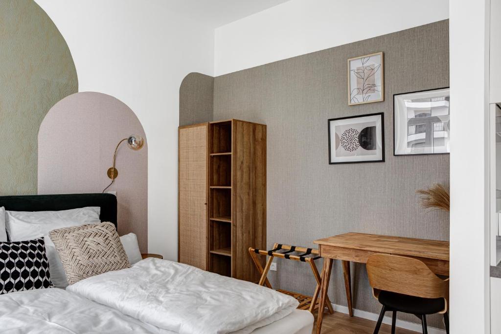 a bedroom with a bed and a desk at Arbio I Luxury Apartments in East Side Gallery in Berlin
