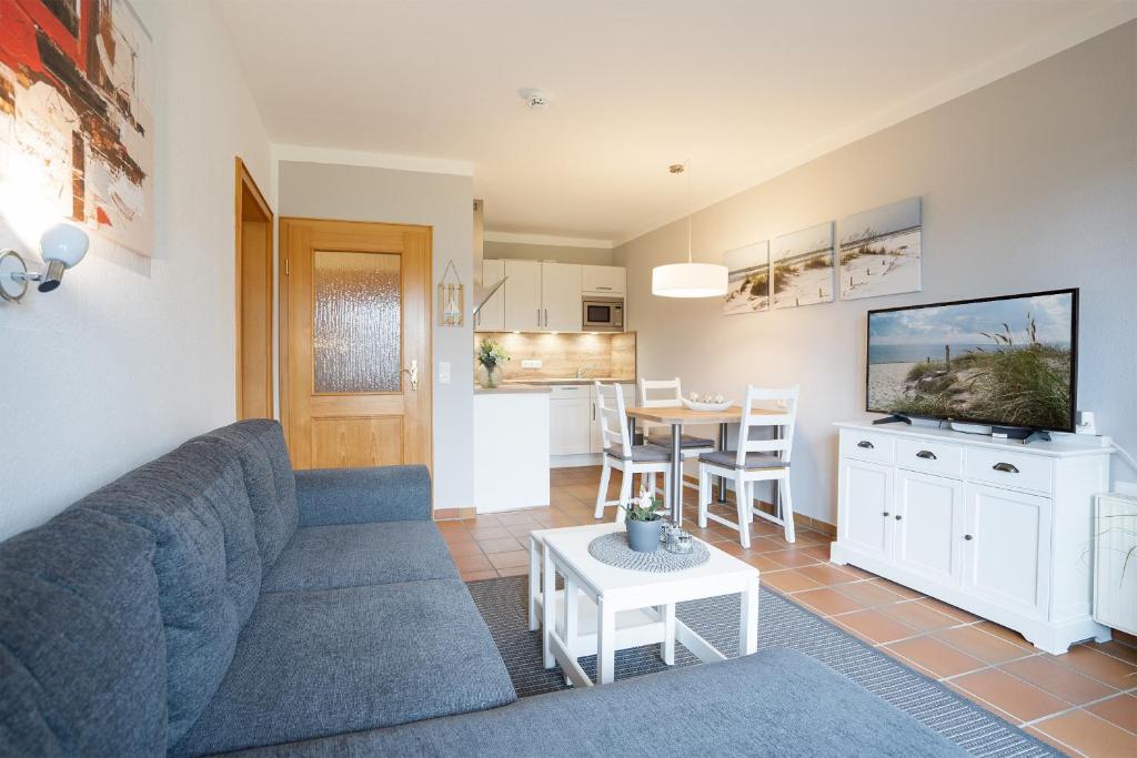 ein Wohnzimmer mit einem Sofa und einem Tisch in der Unterkunft Landhaus Pönitz am See Wohnung 7 in Pönitz am See