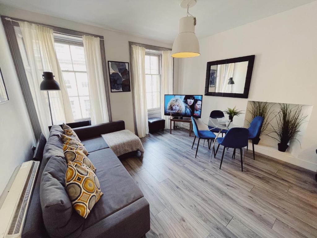 a living room with a couch and a dining room at Newcastle City Centre, Two Bedroom, Sleeps 6 in Newcastle upon Tyne