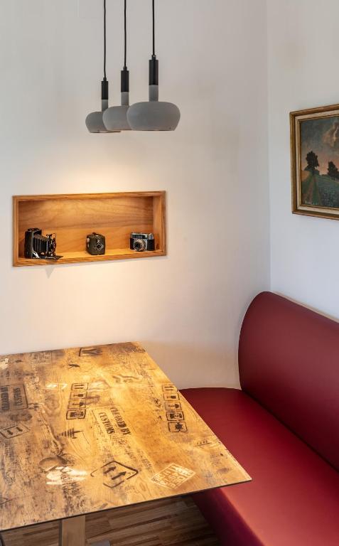 a room with a wooden table with two cameras at Pannonia Appartements 2 in Neusiedl am See