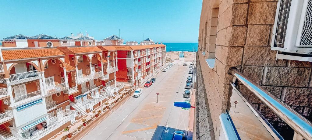 an aerial view of a street with buildings and the ocean at TORRE La MATA Apartamento in La Mata
