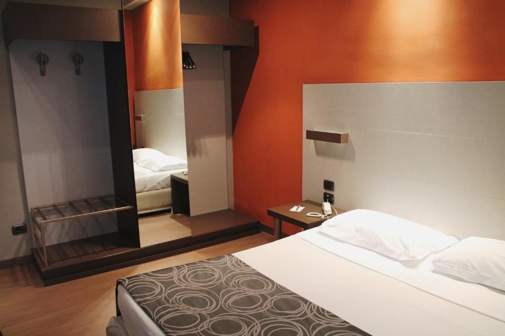Postel nebo postele na pokoji v ubytování Hotel Soperga