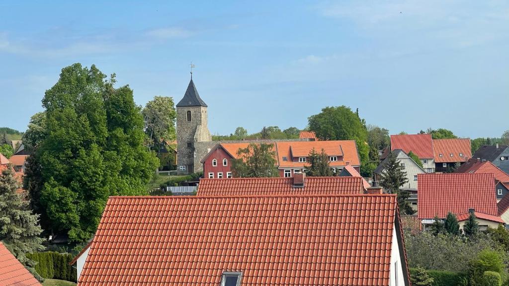 a view of a town with red roofs and a church at Ferienwohnung Weitsicht in Hüttenrode