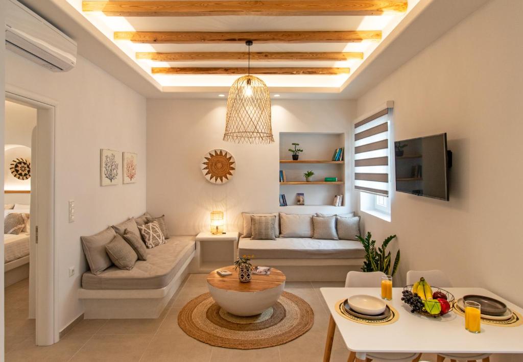 a living room with a couch and a table at Juliano luxury apartments, port of Naxos in Naxos Chora
