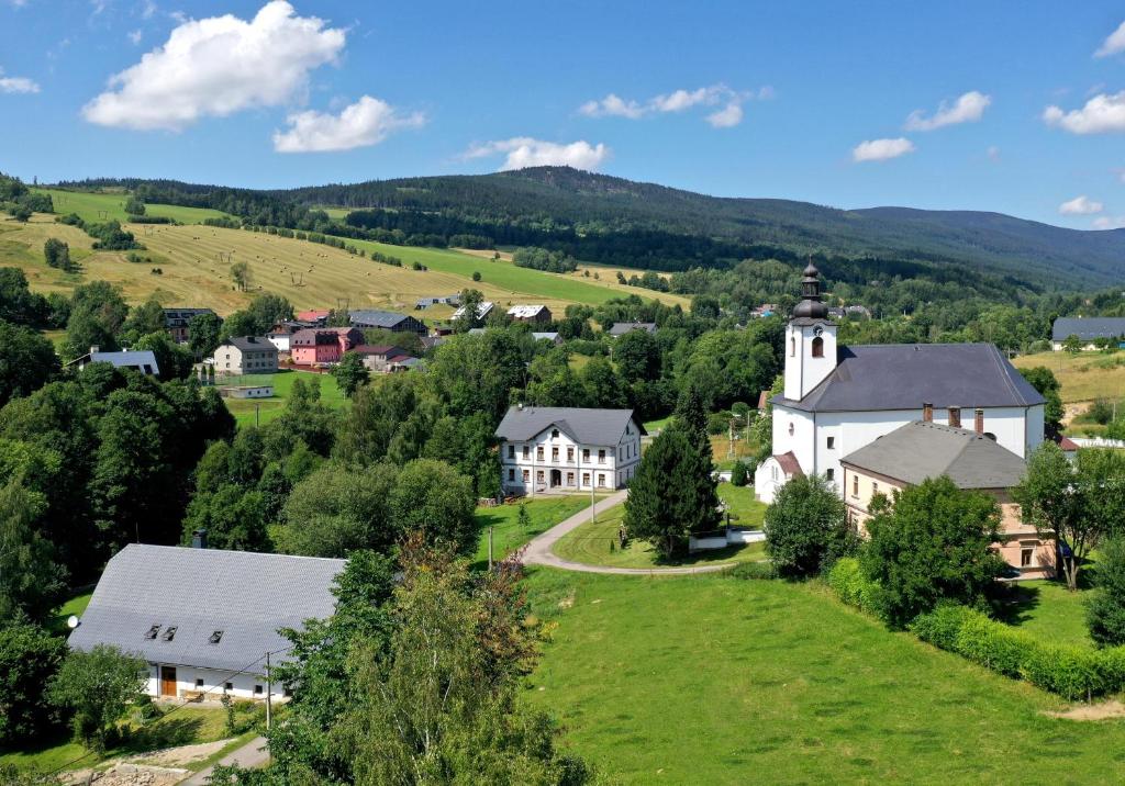 an aerial view of a small village with a church at Apartmány U Aloise in Dolní Morava