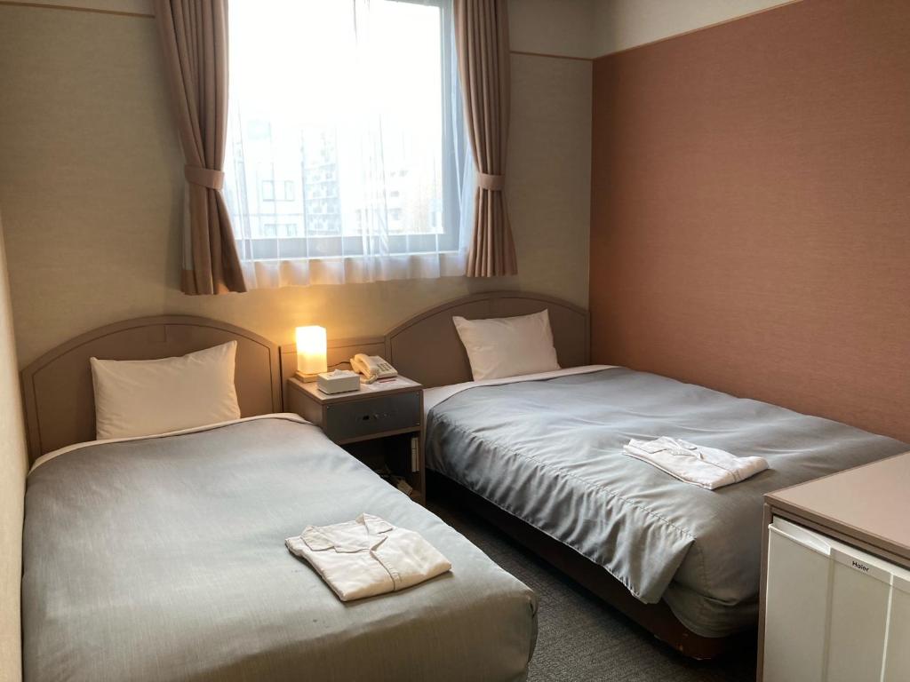 Tempat tidur dalam kamar di Hotel Hamilton Sapporo