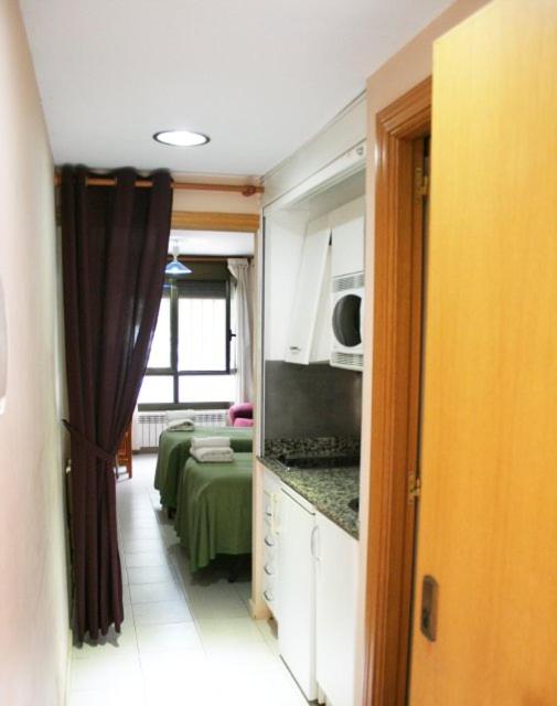 a room with a kitchen and a living room at EL MESON in Mequinenza