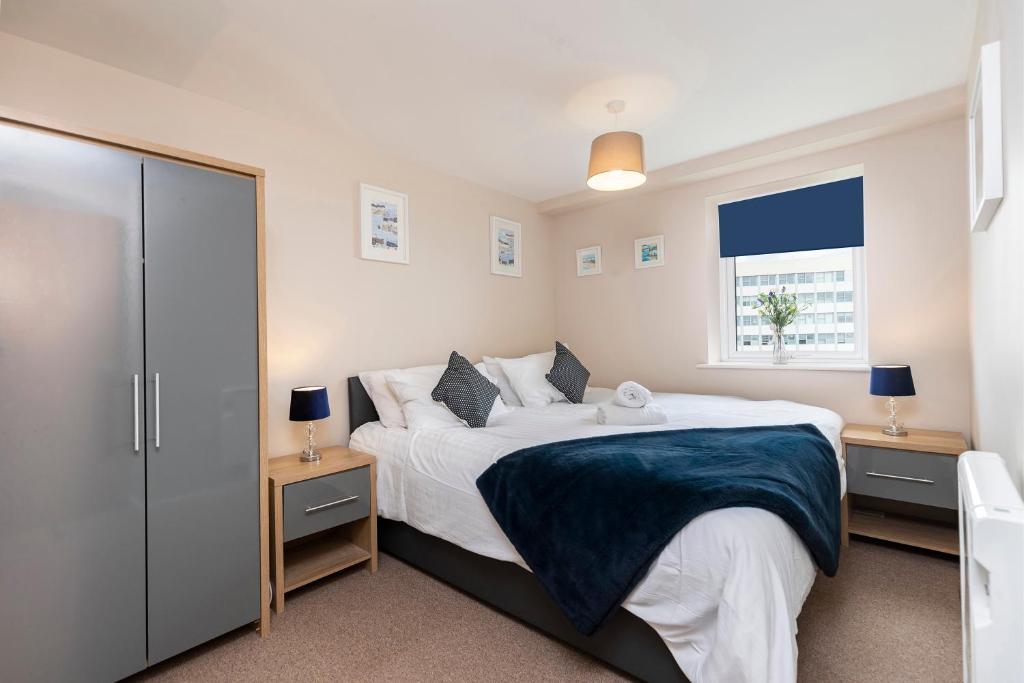 a bedroom with a large bed with two night stands at Oakstays Gateshead in Gateshead