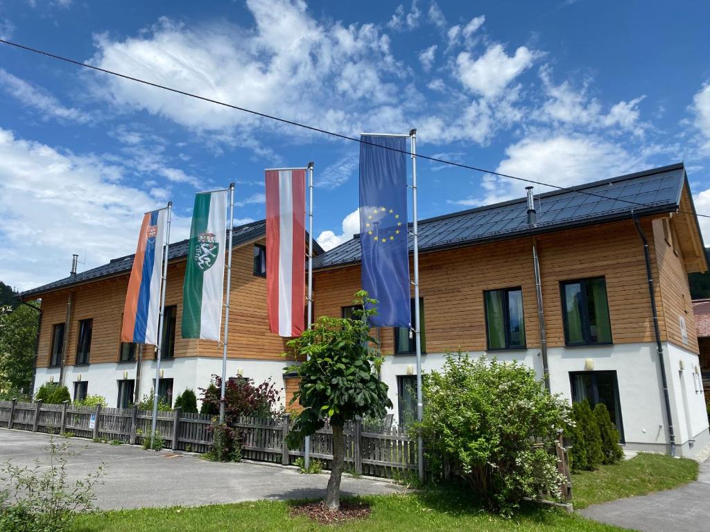 a building with flags on the side of it at Chalet Reiteralm- SKI-IN SKI-OUT in Schladming