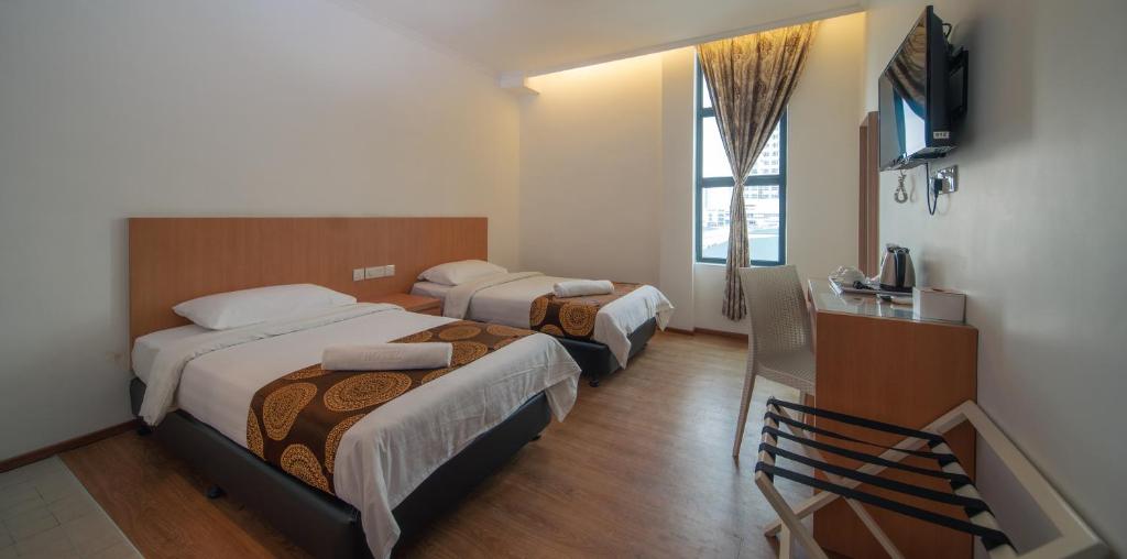 Postel nebo postele na pokoji v ubytování 1 Million Hotel