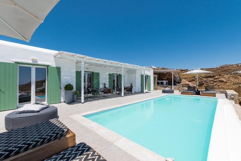 a villa with a swimming pool and a patio at Dioni Villa Mykonos in Paraga