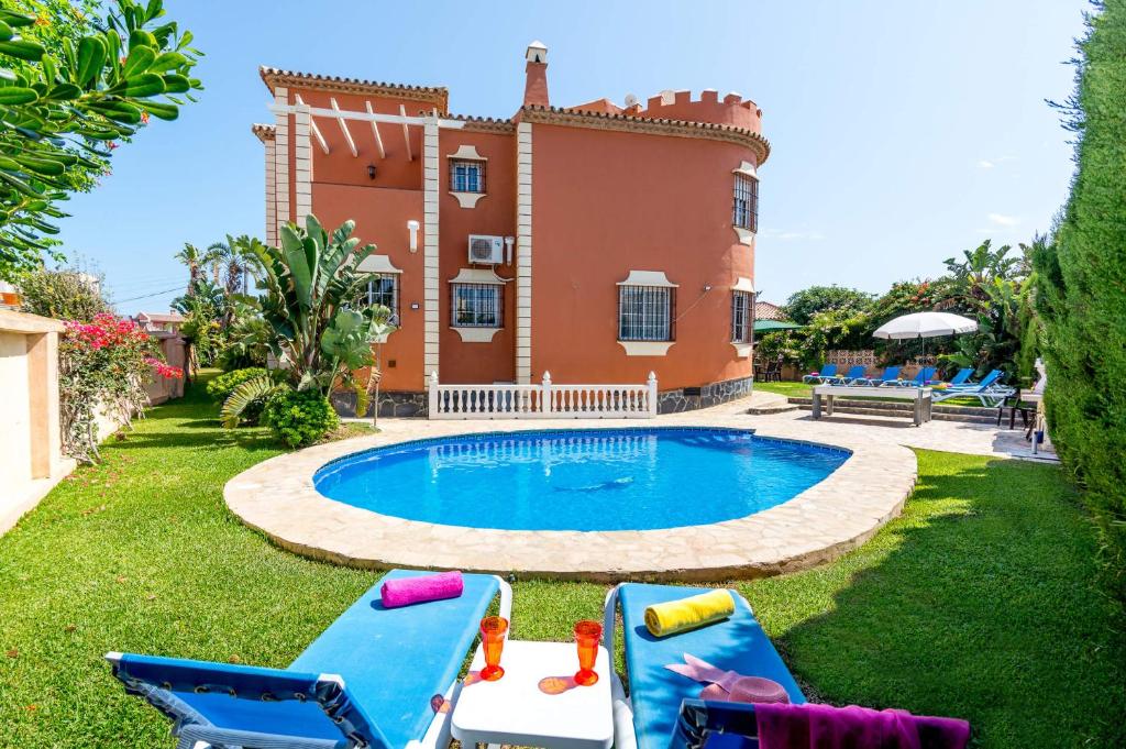 a villa with a swimming pool in front of a house at Villa Mirador Faro by Villa Plus in Mijas Costa