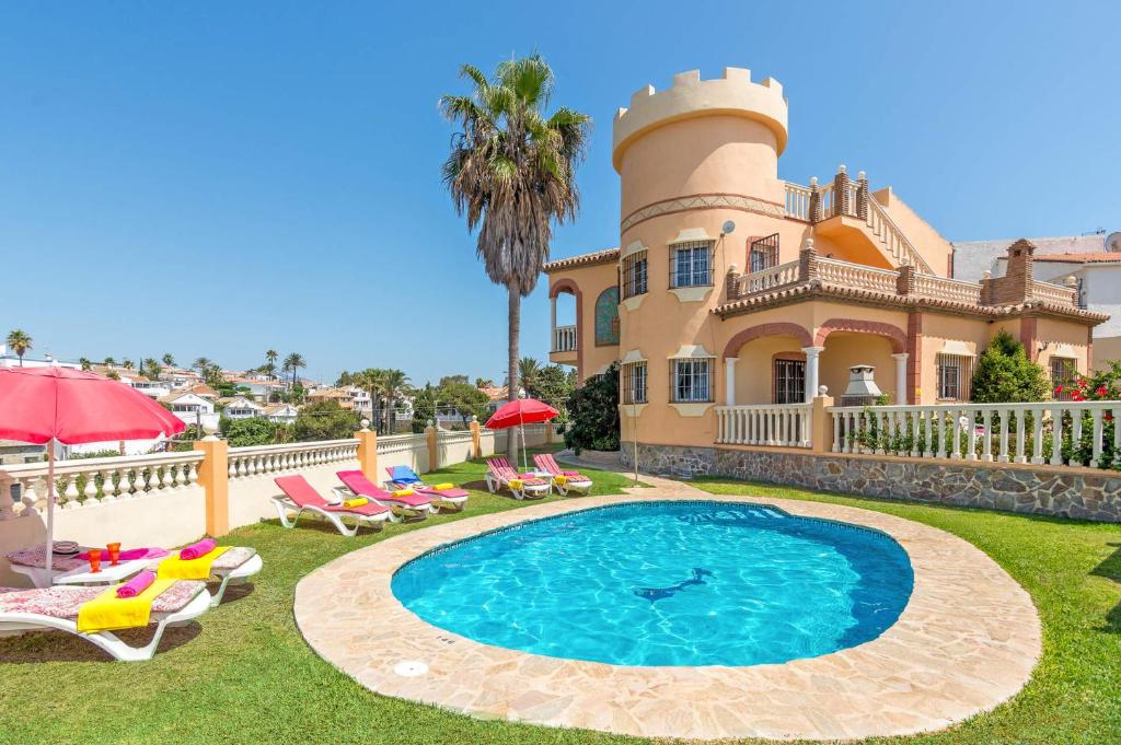 a large house with a swimming pool in the yard at Villa Torreon Faro by Villa Plus in Mijas Costa