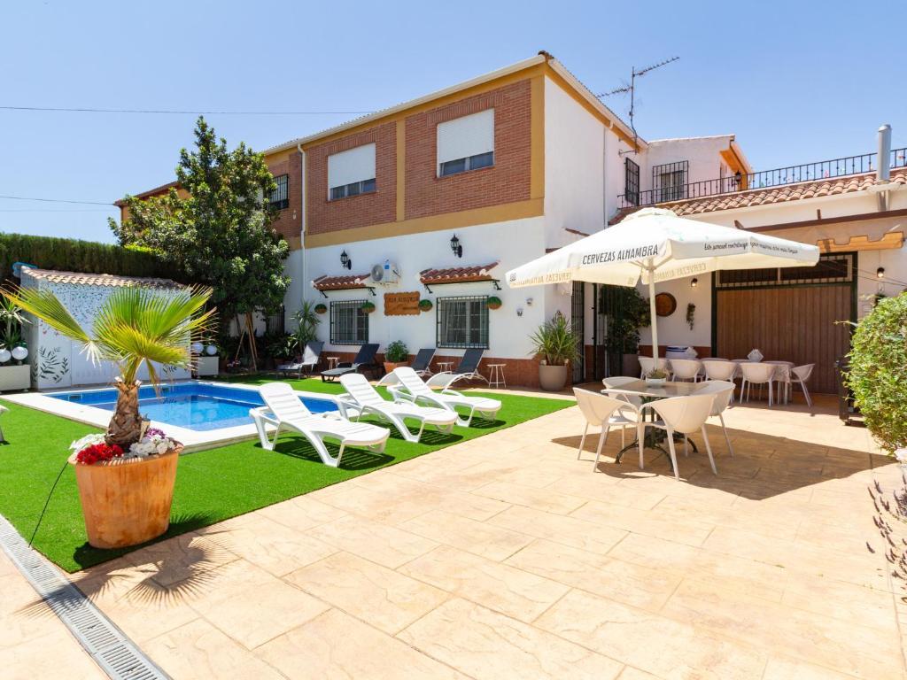 a villa with a swimming pool and a patio at Casa alegría in Dúrcal
