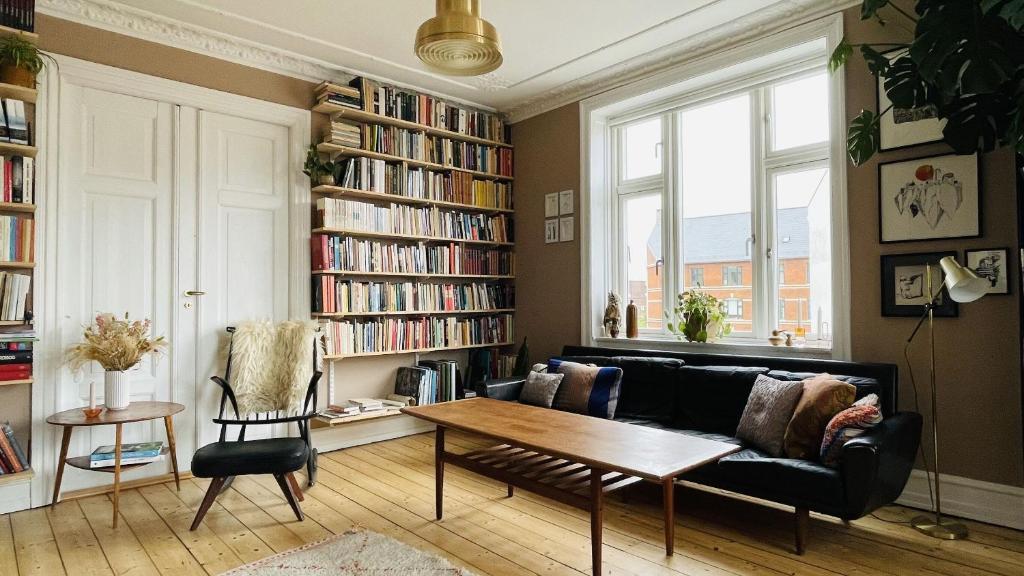 a living room with a couch and a table at ApartmentInCopenhagen Apartment 1494 in Copenhagen