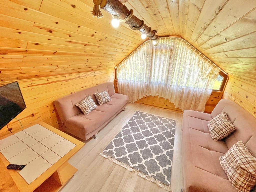 an overhead view of a living room in a log cabin at ŞEN BUTİK OTEL ve BUNGALOV in Uzungol