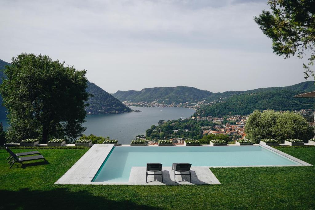 a swimming pool with a view of a lake at Villa ALMANA in Cernobbio