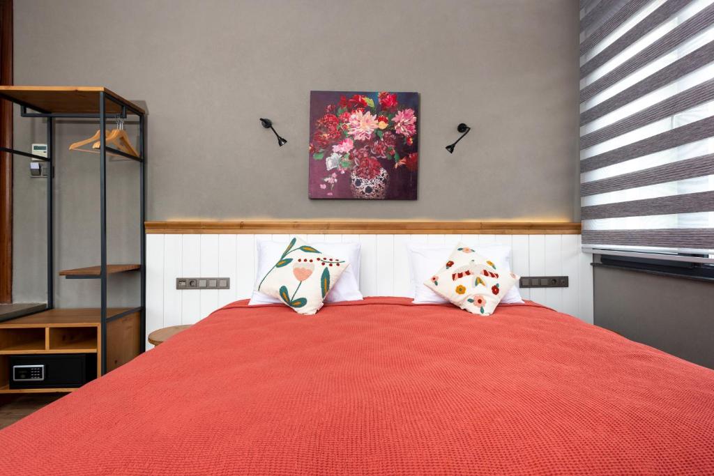 A bed or beds in a room at Istanbul Old City Colorful Houses Balat PETRION Hotel