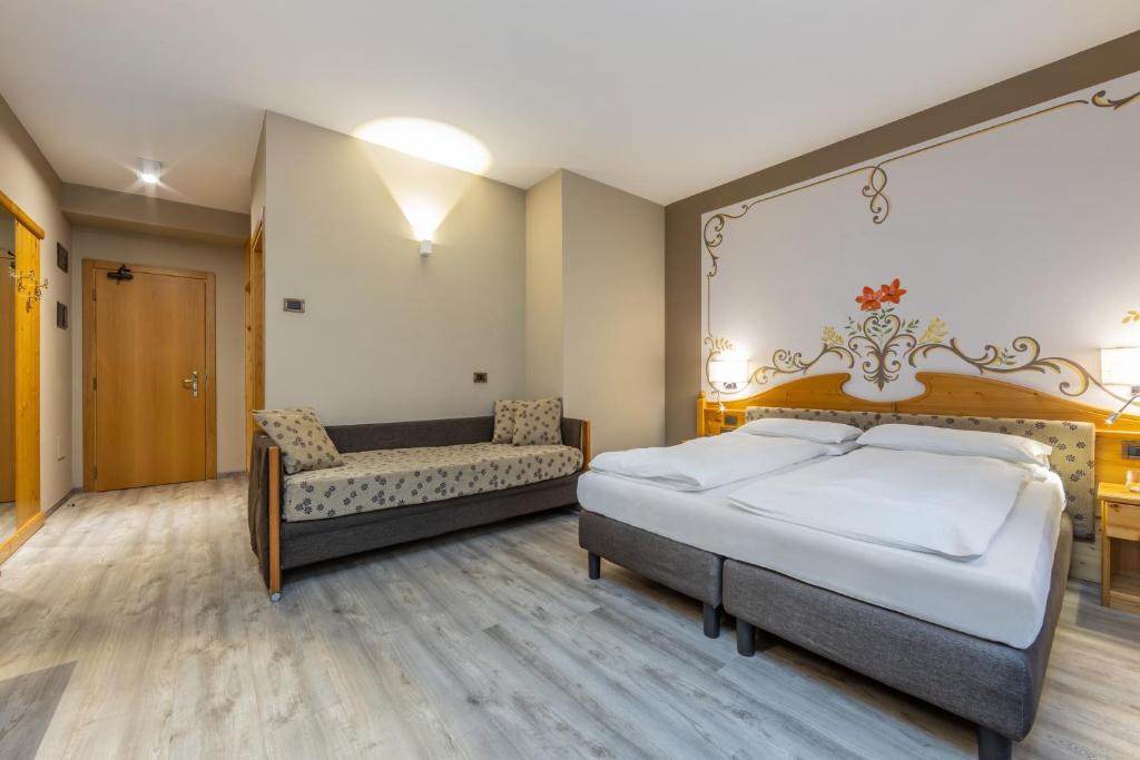 Postel nebo postele na pokoji v ubytování Hotel Vittoria - Ricarica l'anima
