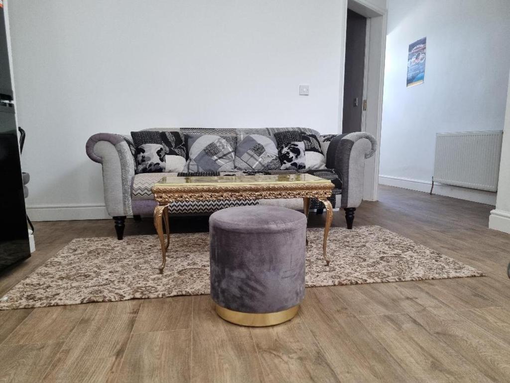 a living room with a couch and a coffee table at Cheerful 4 bedroom close to Uclan, Preston City Center in Preston