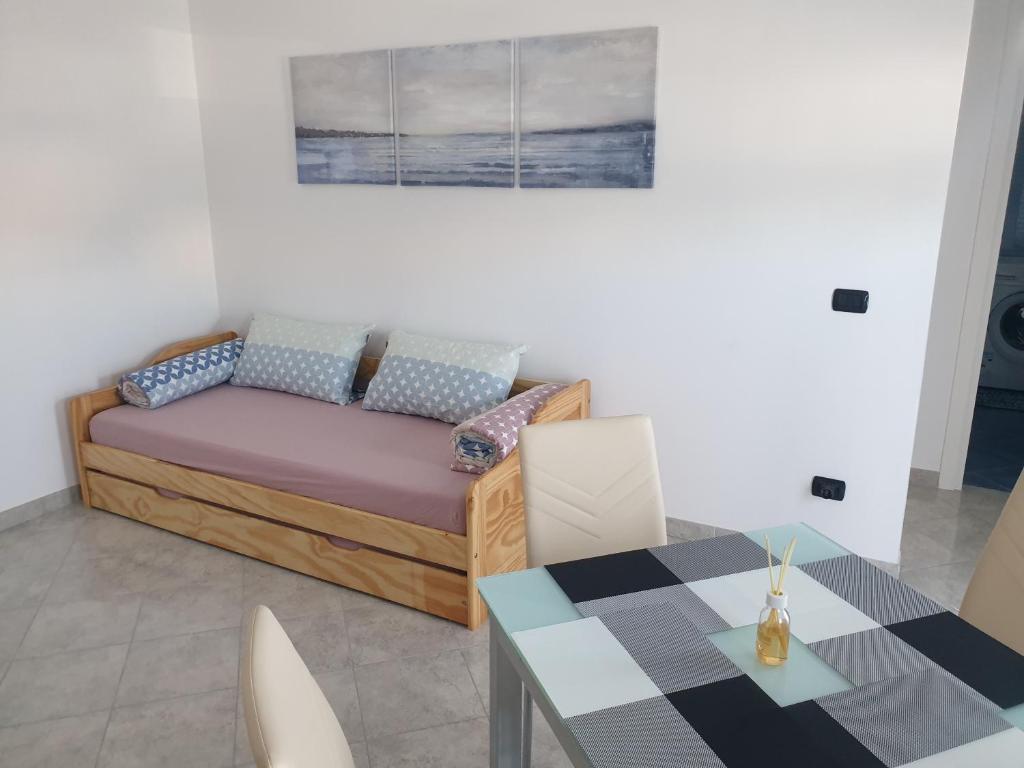 ein Wohnzimmer mit einem Sofa und einem Tisch in der Unterkunft Casa Marisa, 40 metri dalla spiaggia in Vallecrosia