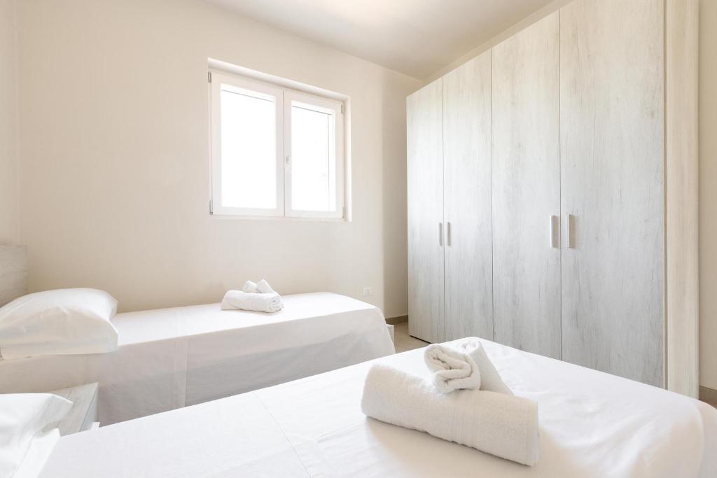 Łóżko lub łóżka w pokoju w obiekcie Villa La Seta by Perle di Puglia