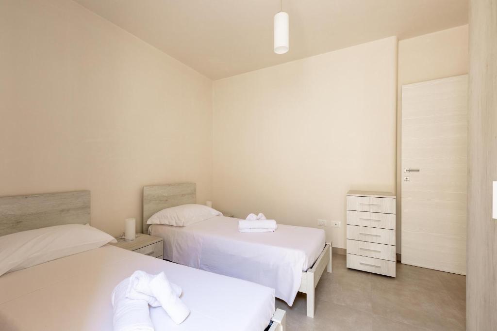 Łóżko lub łóżka w pokoju w obiekcie Villa La Seta by Perle di Puglia