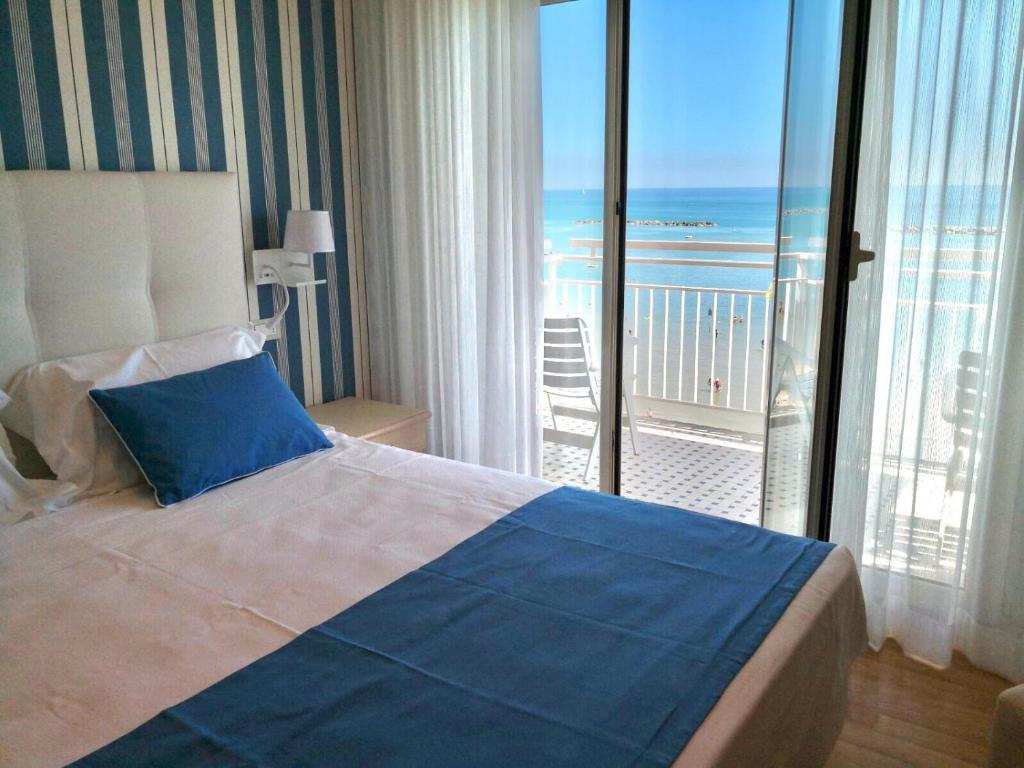 Postel nebo postele na pokoji v ubytování Hotel Sporting