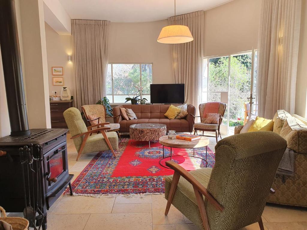 uma sala de estar com um sofá e uma lareira em Villa Dadia - Rosh Pina em Rosh Pinna
