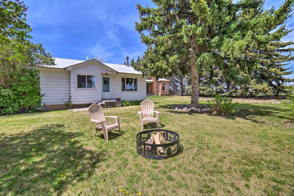 a yard with two chairs and a fire pit at Idaho Falls Farmhouse about 11 Mi to Downtown! in Idaho Falls