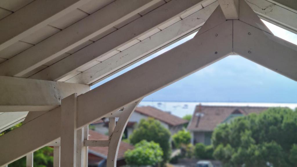 - une vue sur une terrasse couverte en bois avec un toit en bois dans l'établissement Joli duplex au centre du Canon à quelques pas du Bassin, à Cap-Ferret