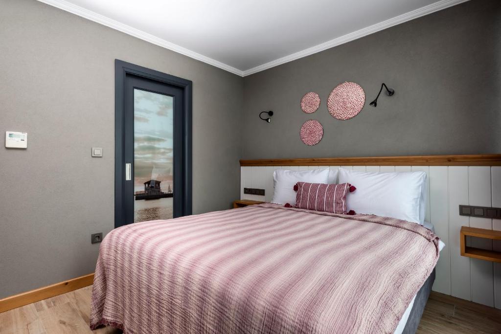 A bed or beds in a room at Istanbul Old City Colorful Houses Balat PETRION Hotel