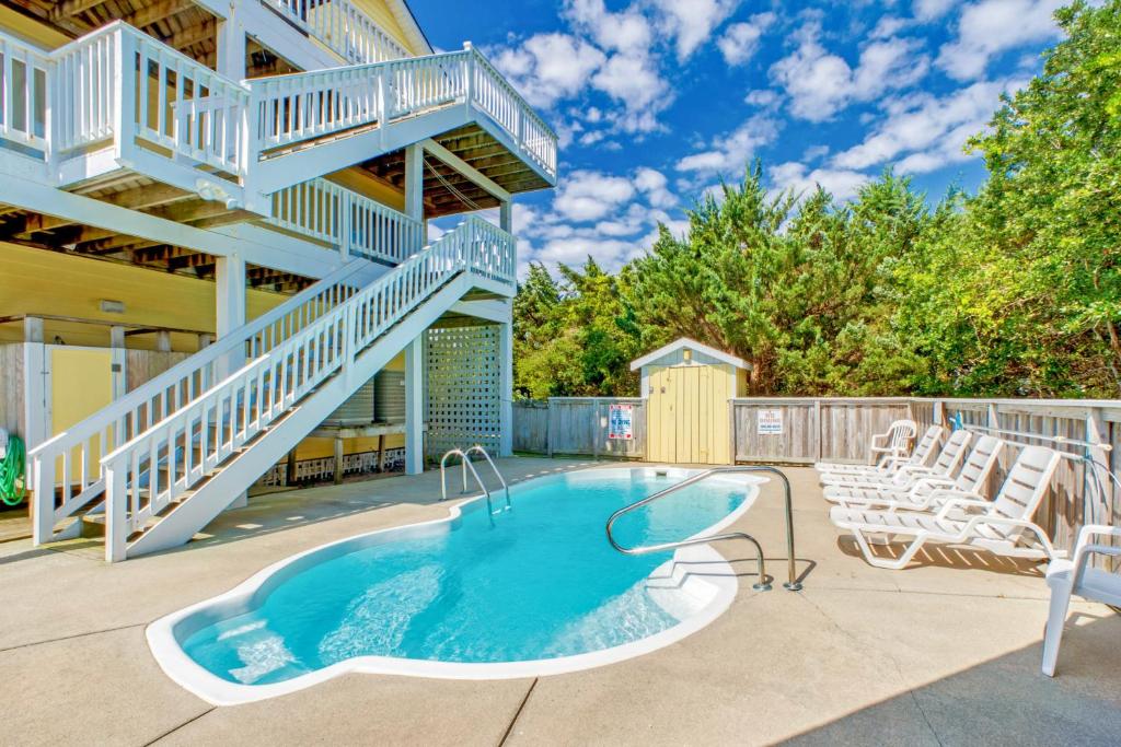 a house with a swimming pool and a staircase at Under The Boardwalk in Avon