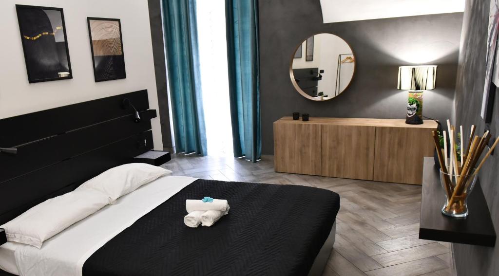 a bedroom with a bed with a teddy bear on it at Apartments Casa Vacanze Dante in Catania