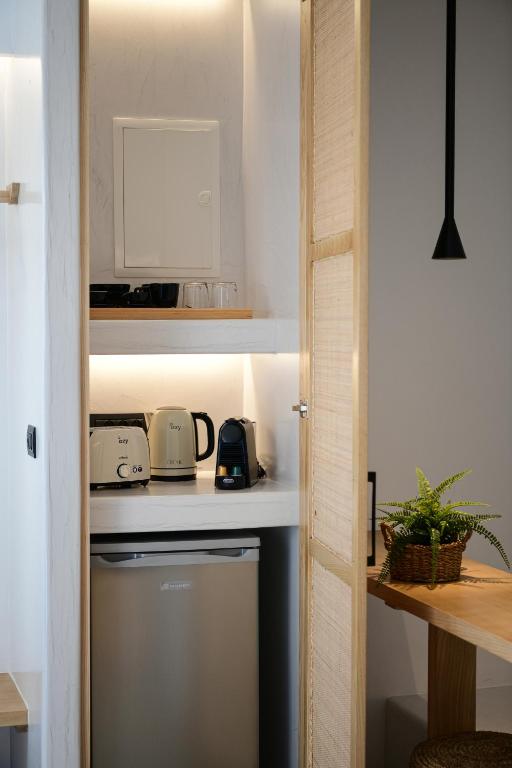 a kitchen with a counter top and a dishwasher at Ios Art Suites in Ios Chora