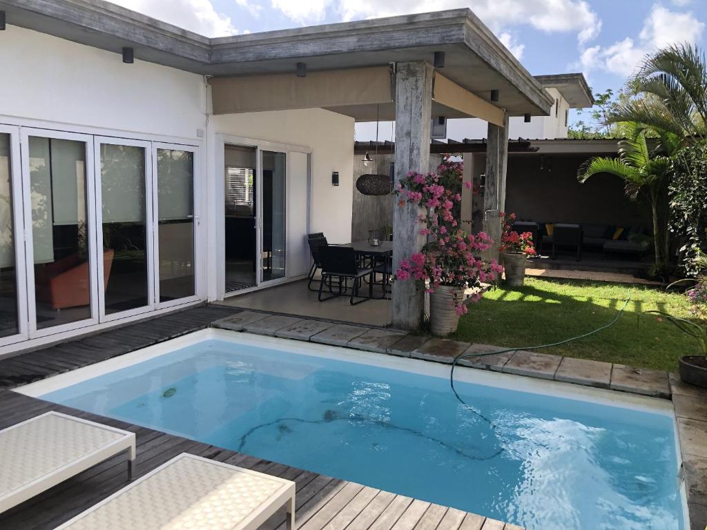 a swimming pool in the backyard of a house at Elegant Villa in Grand Baie with Pool in Grand Baie