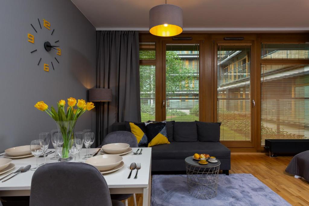a living room with a couch and a table at Kolejowa Apartments Warsaw by Renters in Warsaw