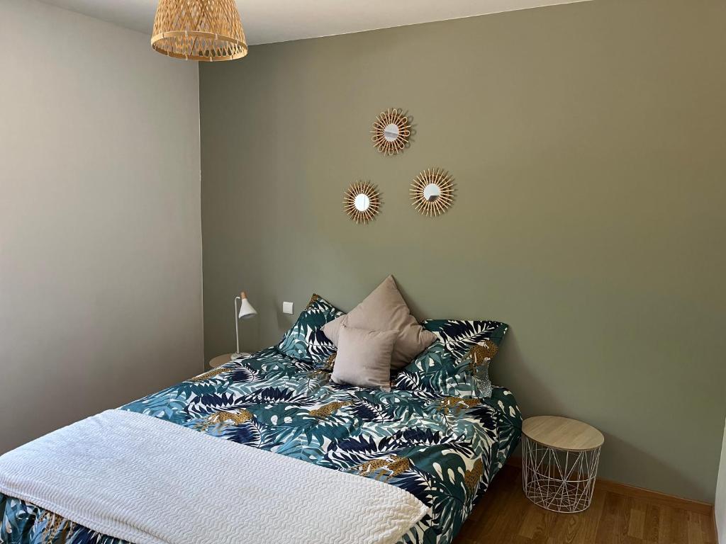 a bedroom with a bed and two mirrors on the wall at Océan à 10 mn, maison avec piscine, bar et babyfoot in Saint-Paul-en-Born