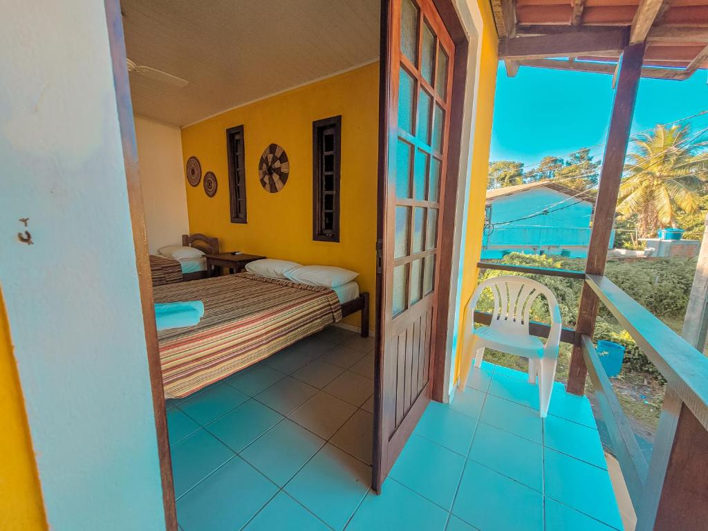 a room with a bed and a balcony at Pousada Casa da Marina in Ilha de Boipeba
