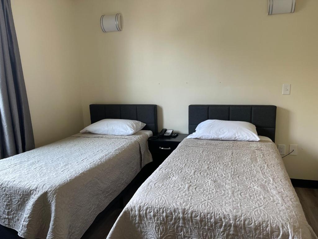 Postel nebo postele na pokoji v ubytování Astoria Inn LaGuardia Hotel