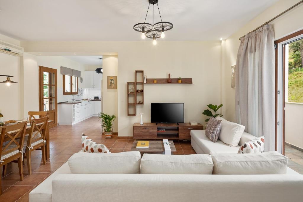 sala de estar con sofá blanco y mesa en Casa Luna D'Argento Corfu, en Virós