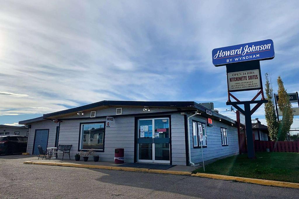 a blue building with a sign in front of it at Howard Johnson by Wyndham Grande Prairie in Grande Prairie