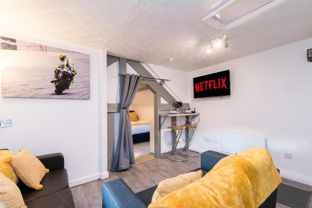 a living room with a couch and a motorcycle on the wall at DD Apartment 8 - Free Parking - Fast Wifi in Castle Donington