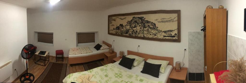 a room with a bedroom with a bed and a desk at Prenoćište Gany in Jajce