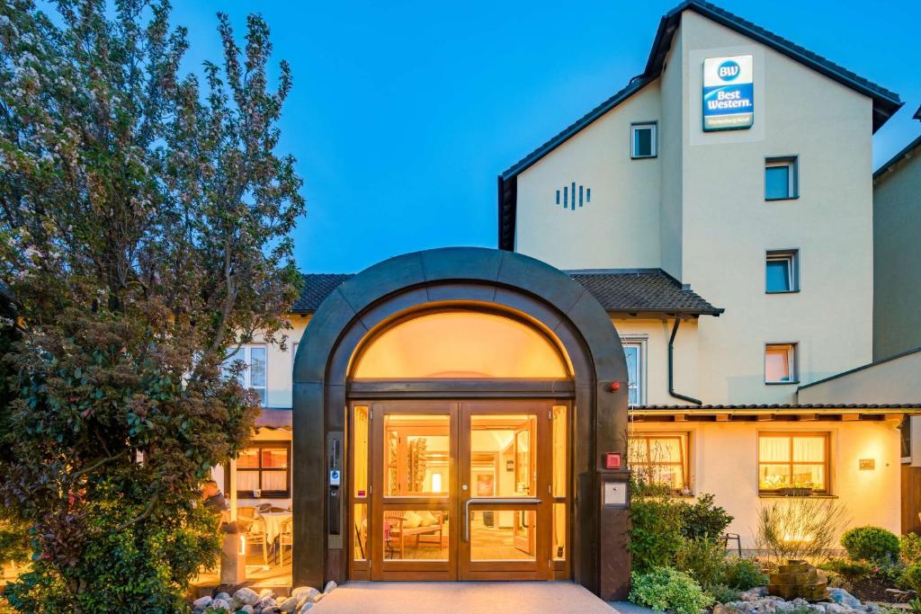 a building with a large door in front of it at Best Western Blankenburg Hotel in Coburg